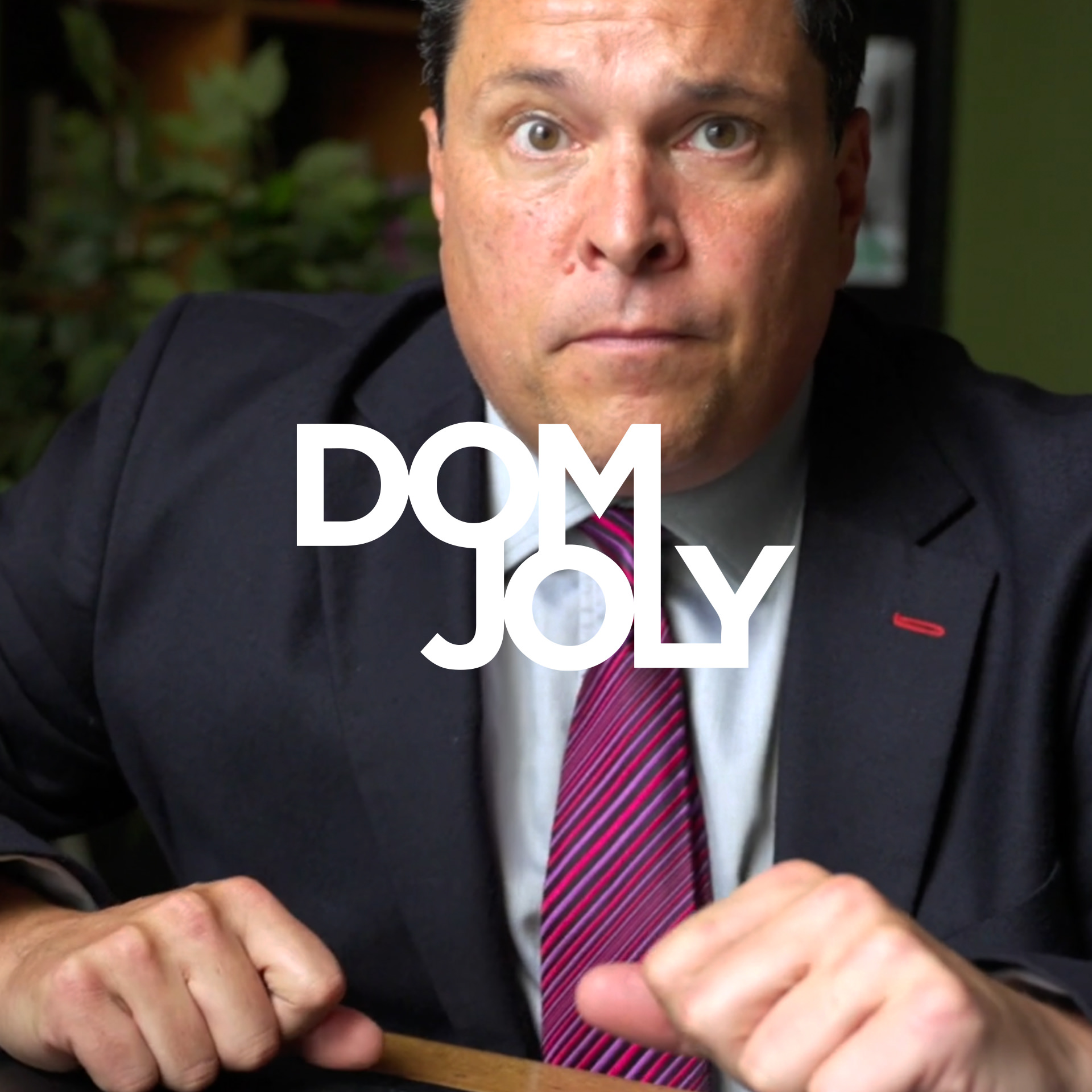 Dom Joly from TV show, Trigger Happy TV. Dom is looking straight at the camera with a confused expression.